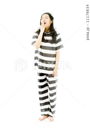 Young Asian woman yawning in prisoners uniform 11176634