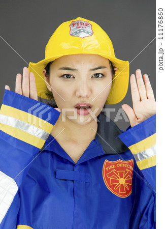 Lady firefighter making stop gesture 11176860