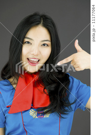 Asian air stewardess pointing at herself Asian air stewardess pointing at herself 11177064