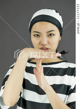 Young Asian woman making time out signal with hands in prisoners uniform 11177152