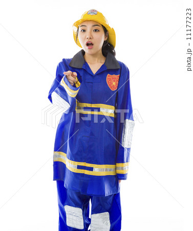 Shocked lady firefighter with pointing isolated on white background 11177223