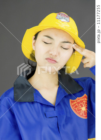 Close up of a lady firefighter pointing imaginary gun to her head Close up of a lady firefighter pointing imaginary gun to her head 11177255