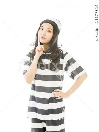 Young Asian woman with finger on chin in prisoners uniform Young Asian woman with finger on chin in prisoners uniform 11177314