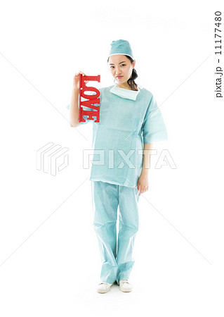 Disappointed Asian female surgeon holding red "LOVE" text Disappointed Asian female surgeon holding red "LOVE" text 11177480