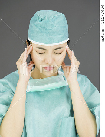 Asian female surgeon suffering from headache 11177494