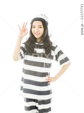 Young Asian woman showing OK sign in prisoners uniform Young Asian woman showing OK sign in prisoners uniform 11177731