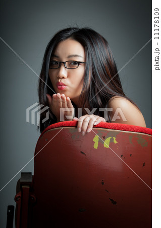 Attractive Asian girl 20s at the theatre isolate white backgroun 11178109
