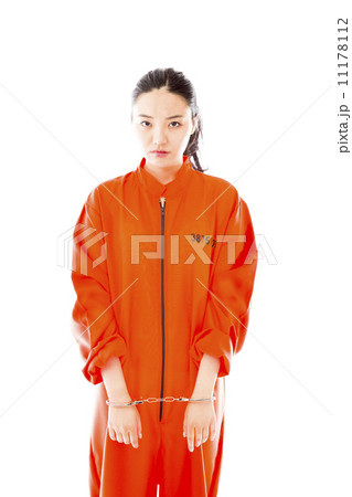 Handcuffed Asian young woman in prisoners uniform 11178112