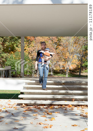 Woman carrying her baby boy and moving in a park Woman carrying her baby boy and moving in a park 11178189