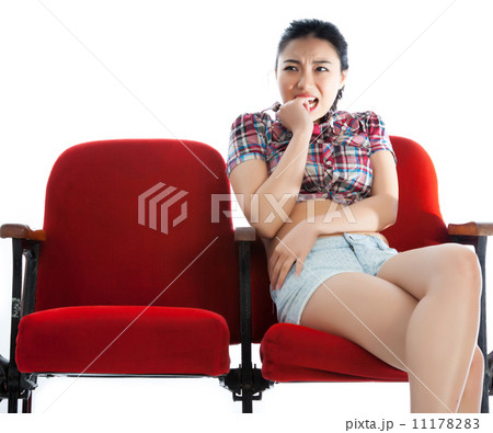 Attractive Asian girl 20s at the theatre isolate white backgroun 11178283