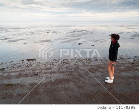 Woman standing on the coast, Quebec, Canada Woman standing on the coast, Quebec, Canada 11178298