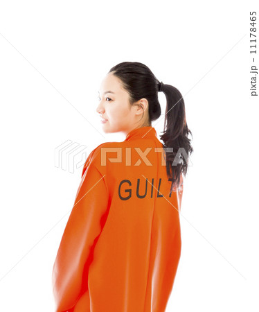 Side profile of a young Asian woman in prisoners uniform Side profile of a young Asian woman in prisoners uniform 11178465