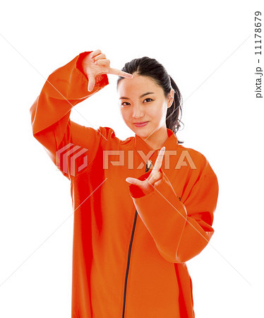 Young Asian woman making frame with fingers in prisoners uniform Young Asian woman making frame with fingers in prisoners uniform 11178679