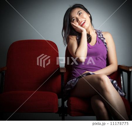 Attractive Asian girl 20s at the theatre isolate white backgroun 11178775
