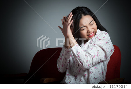 Attractive Asian girl 20s at the theatre isolate white backgroun 11179014