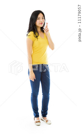 Young Asian woman standing with finger crossed Young Asian woman standing with finger crossed 11179057