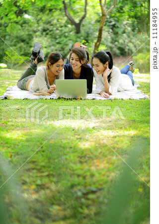 Asian girls with notebook computer in park Asian girls with notebook computer in park 11184955
