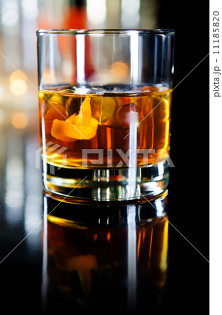 Glass of whiskey with ice cubes and fruits Glass of whiskey with ice cubes and fruits 11185820