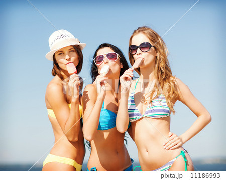 girls in bikinis with ice cream on the beach girls in bikinis with ice cream on the beach 11186993