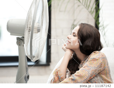 happy and smiling woman sitting near ventilator happy and smiling woman sitting near ventilator 11187142
