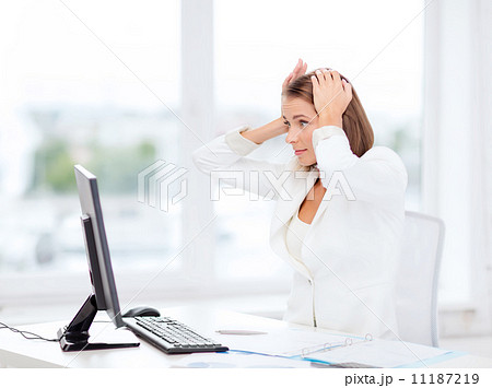 stressed businesswoman with computer at work stressed businesswoman with computer at work 11187219