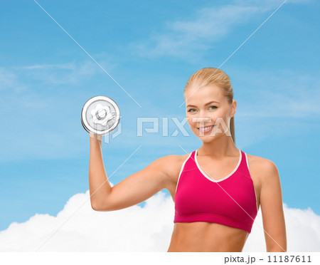 smiling woman with heavy steel dumbbell smiling woman with heavy steel dumbbell 11187611