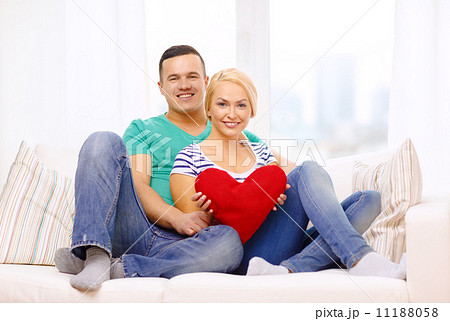 smiling happy couple with red heart at home smiling happy couple with red heart at home 11188058