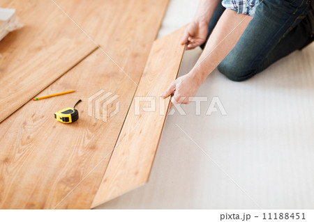 close up of male hands intalling wood flooring close up of male hands intalling wood flooring 11188451