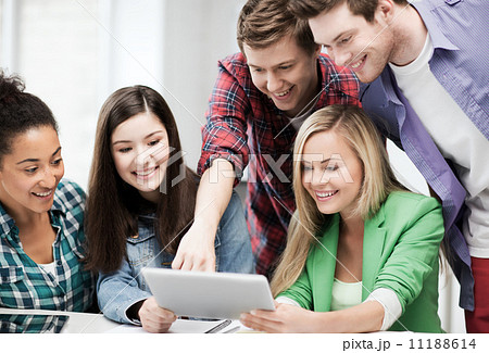 students looking at tablet pc in lecture at school 11188614
