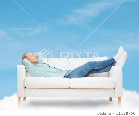 smiling man lying on sofa smiling man lying on sofa 11188750