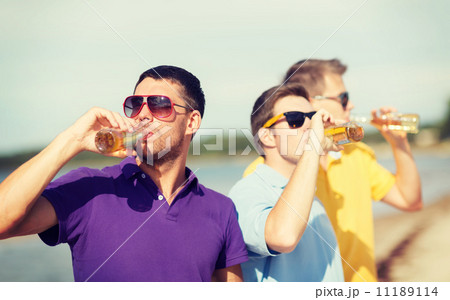 friends on the beach with bottles of drink friends on the beach with bottles of drink 11189114