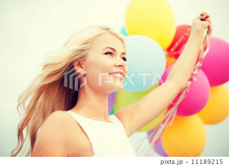 woman with colorful balloons outside woman with colorful balloons outside 11189215