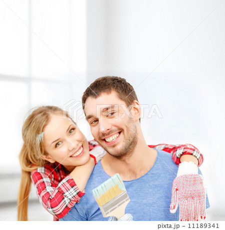 smiling couple covered with paint with paint brush smiling couple covered with paint with paint brush 11189341