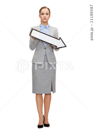 serious businesswoman with direction arrow sign 11189387