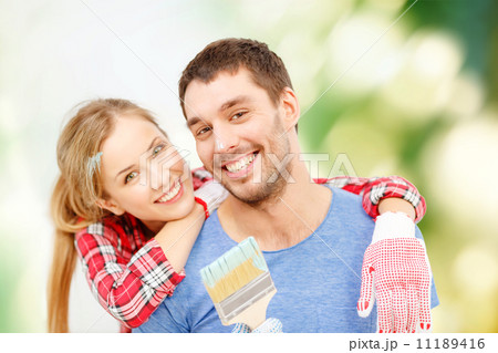 smiling couple covered with paint with paint brush smiling couple covered with paint with paint brush 11189416