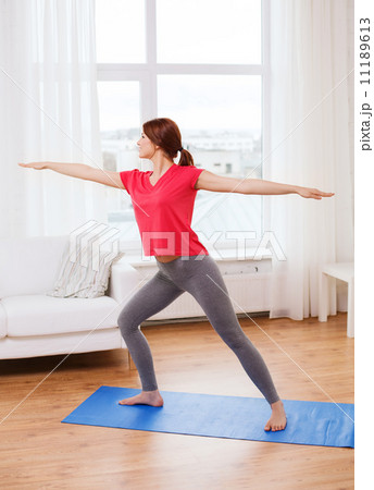 smiling teenage girl streching at home smiling teenage girl streching at home 11189613