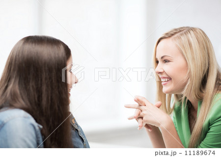 student girls gossiping at school 11189674