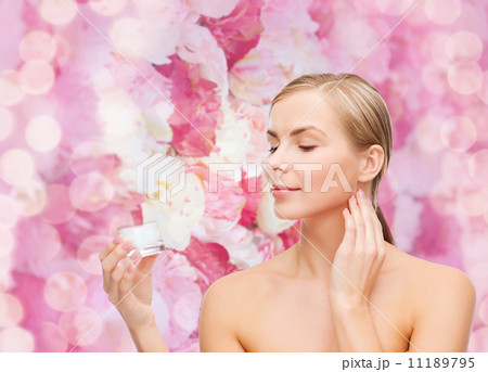 woman applying cream on her skin woman applying cream on her skin 11189795