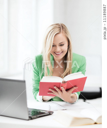 smiling student girl reading book in college smiling student girl reading book in college 11189887