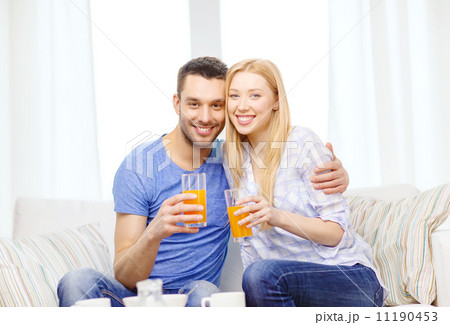 smiling happy couple at home drinking juice 11190453