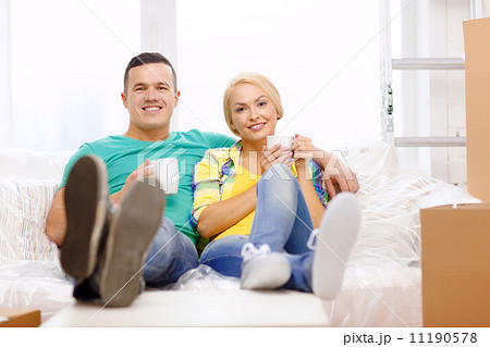 smiling couple relaxing on sofa in new home 11190578