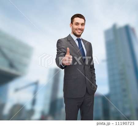 handsome buisnessman showing thumbs up handsome buisnessman showing thumbs up 11190725