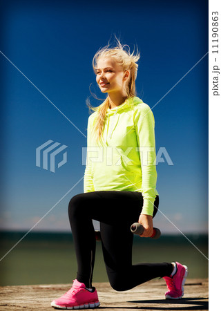sporty woman with light dumbbells outdoors sporty woman with light dumbbells outdoors 11190863