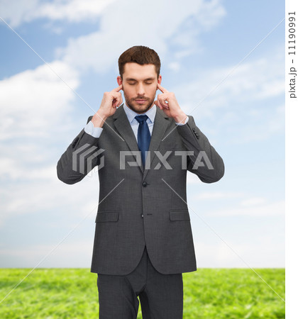 annoyed businessman covering ears with his hands annoyed businessman covering ears with his hands 11190991