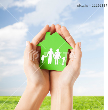 hands holding green house with family hands holding green house with family 11191387