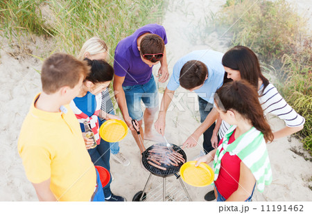 group of friends having picnic and making barbecue group of friends having picnic and making barbecue 11191462