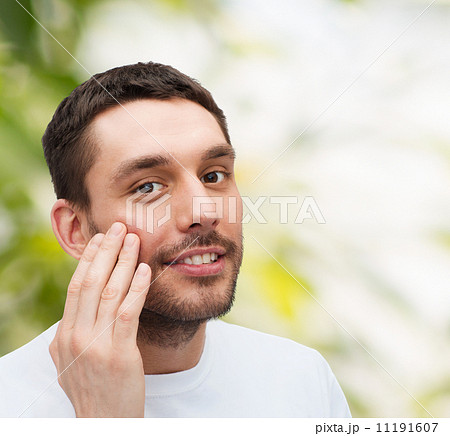 beautiful smiling man touching his face 11191607