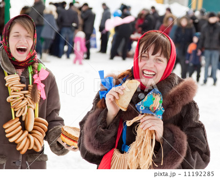 Women tasting pancake during Shrovetide Women tasting pancake during Shrovetide 11192285