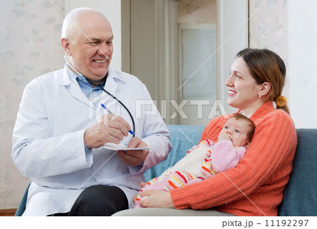 Male mature children's doctor examining newborn baby Male mature children's doctor examining newborn baby 11192297