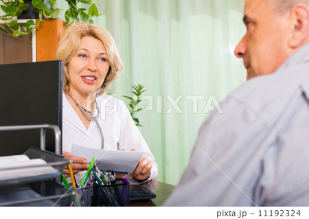 Mature doctor talking with elderly male patient Mature doctor talking with elderly male patient 11192324